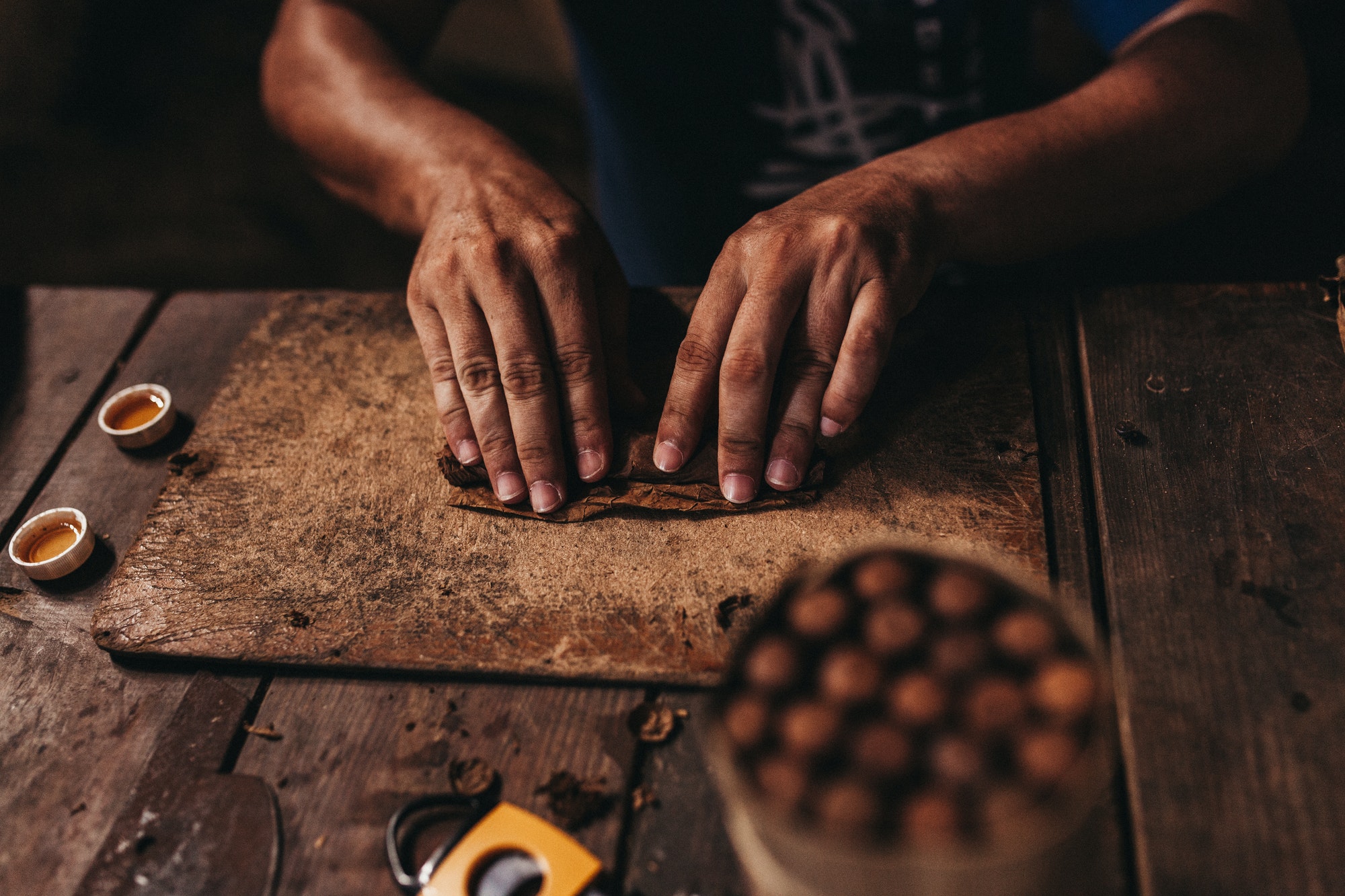 Male hands making cigars